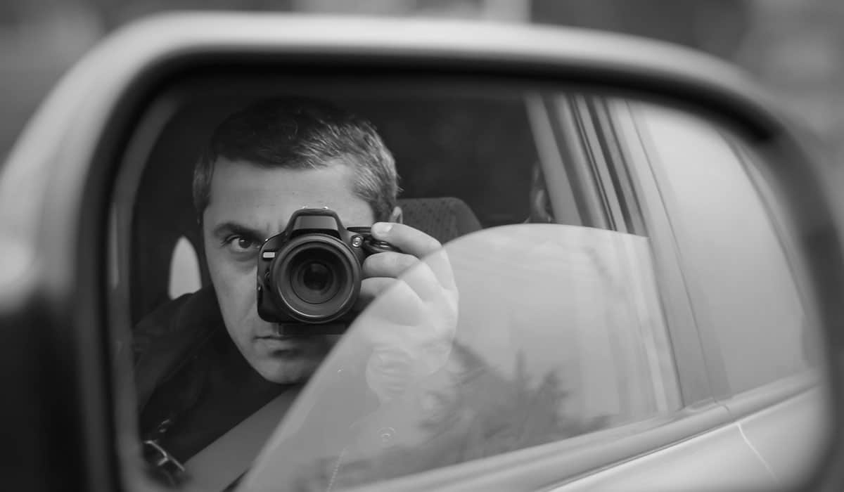 Hire the Best Private Detective in Houston (A person capturing photos sitting in a car)